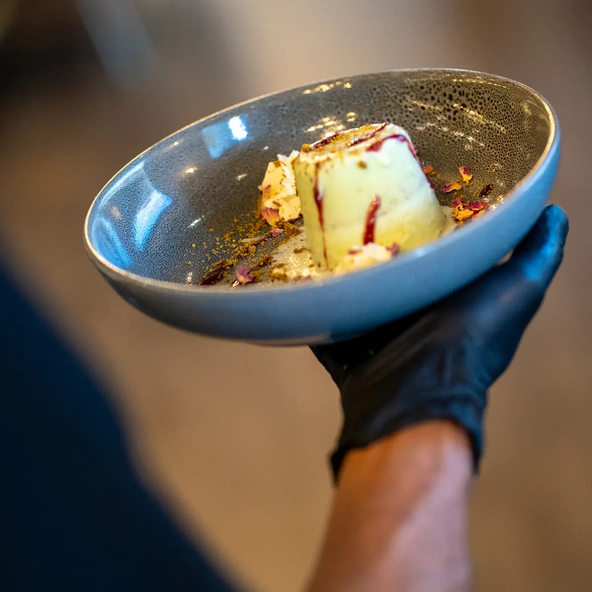 Server holding desert dish.