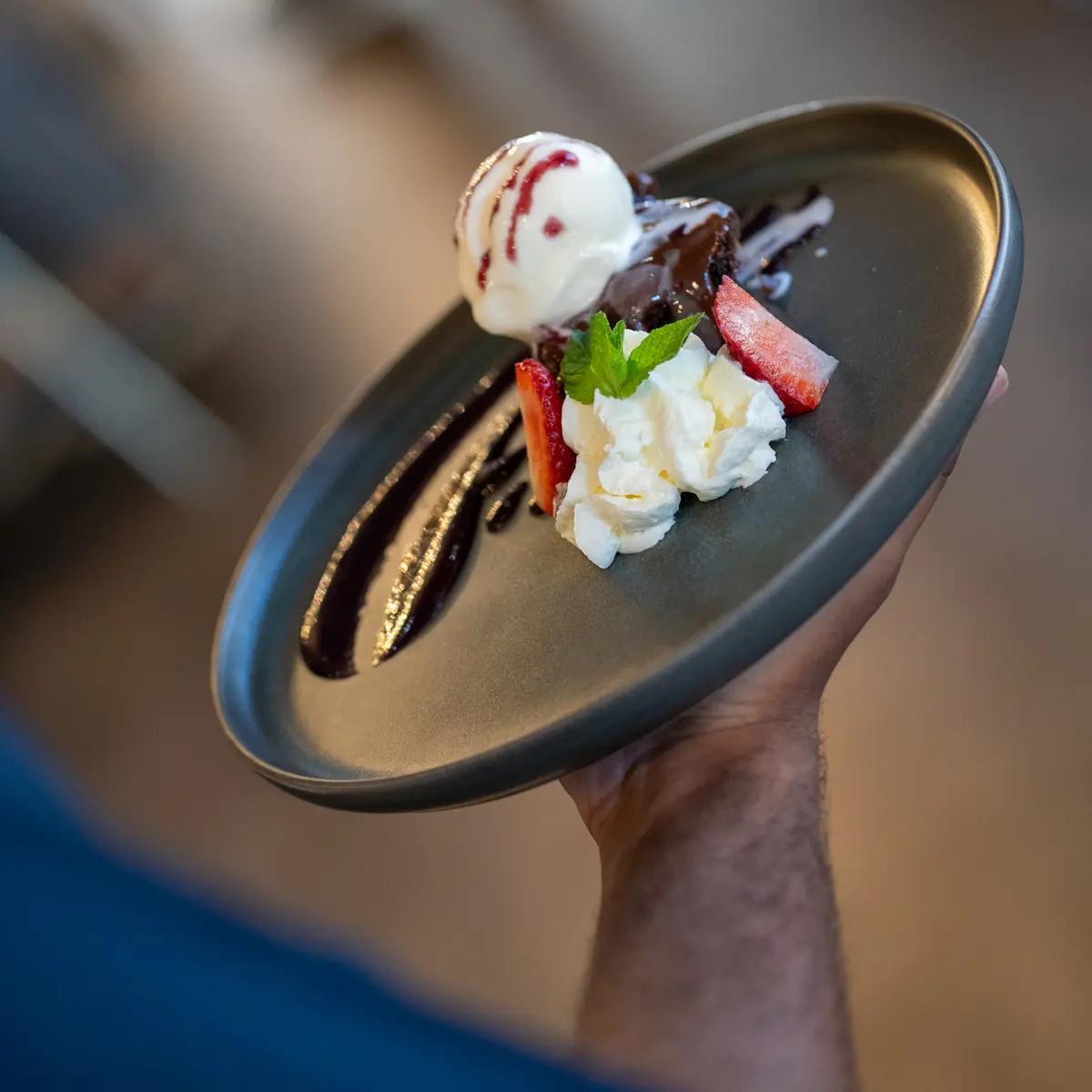 Server holding desert dish.